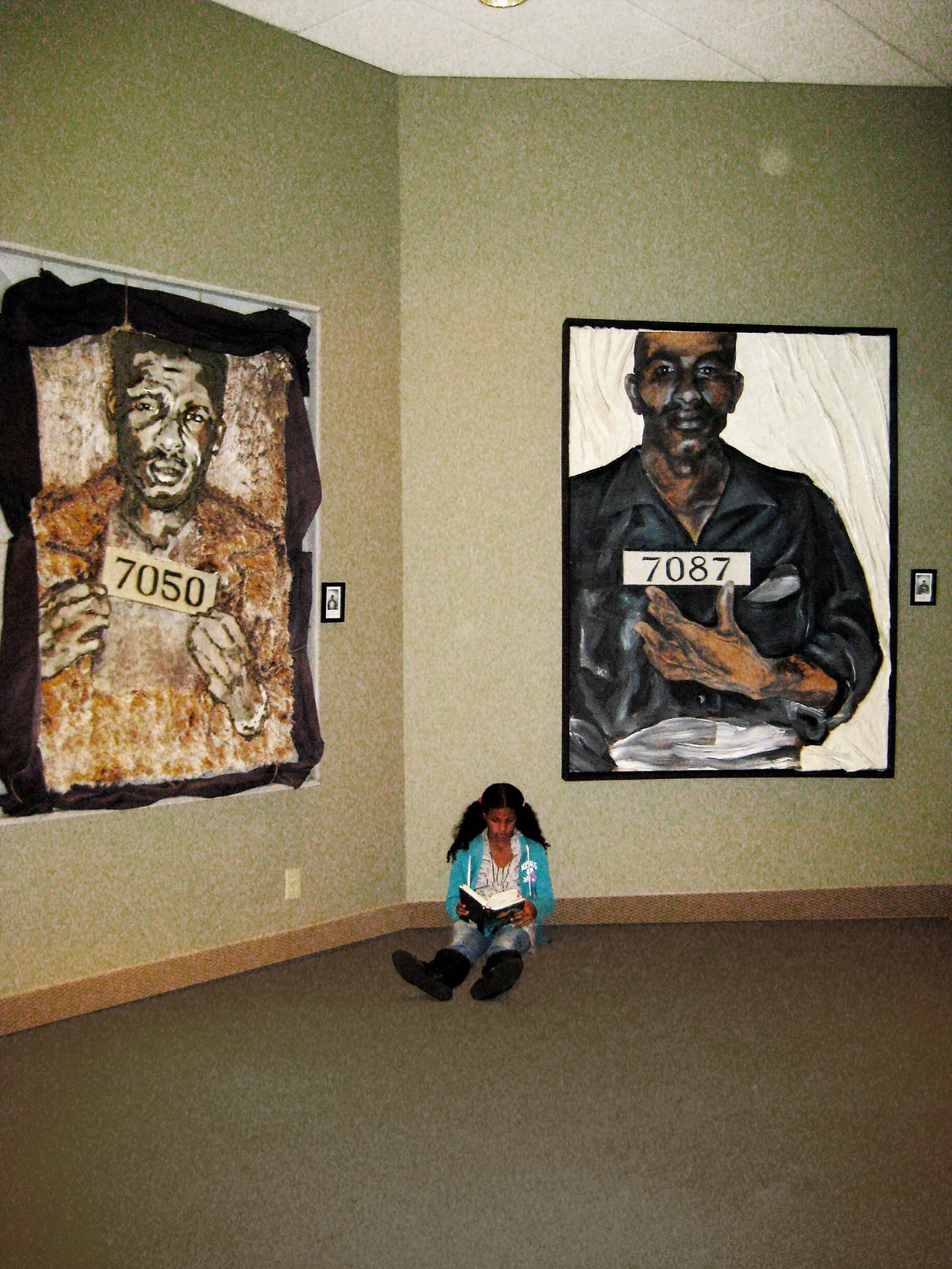 The paintings 7050 and 7087 installed, a girl reading on the gallery floor
