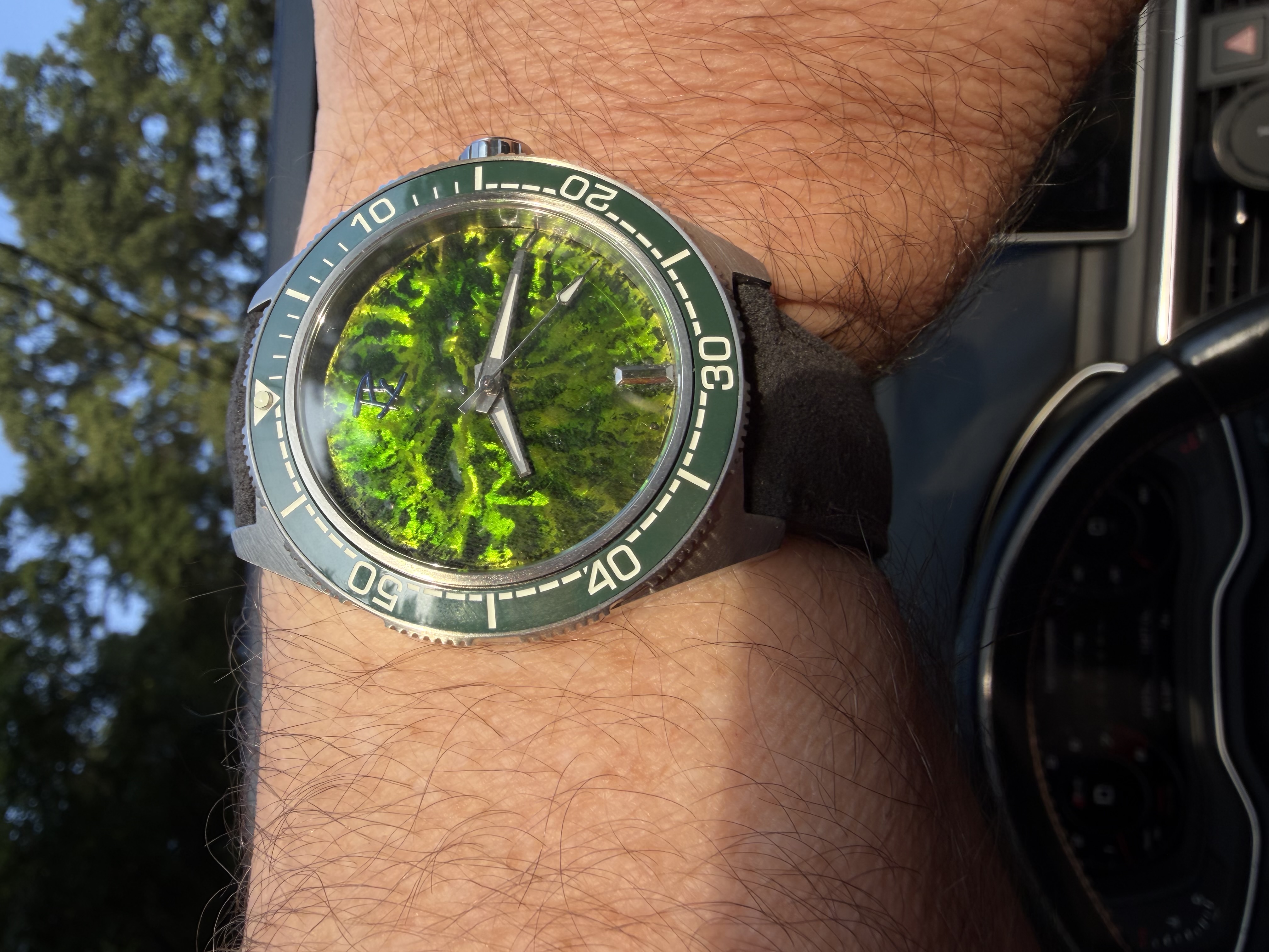 A lime and chartreuse dial in a steel diver case, photographed in direct sun