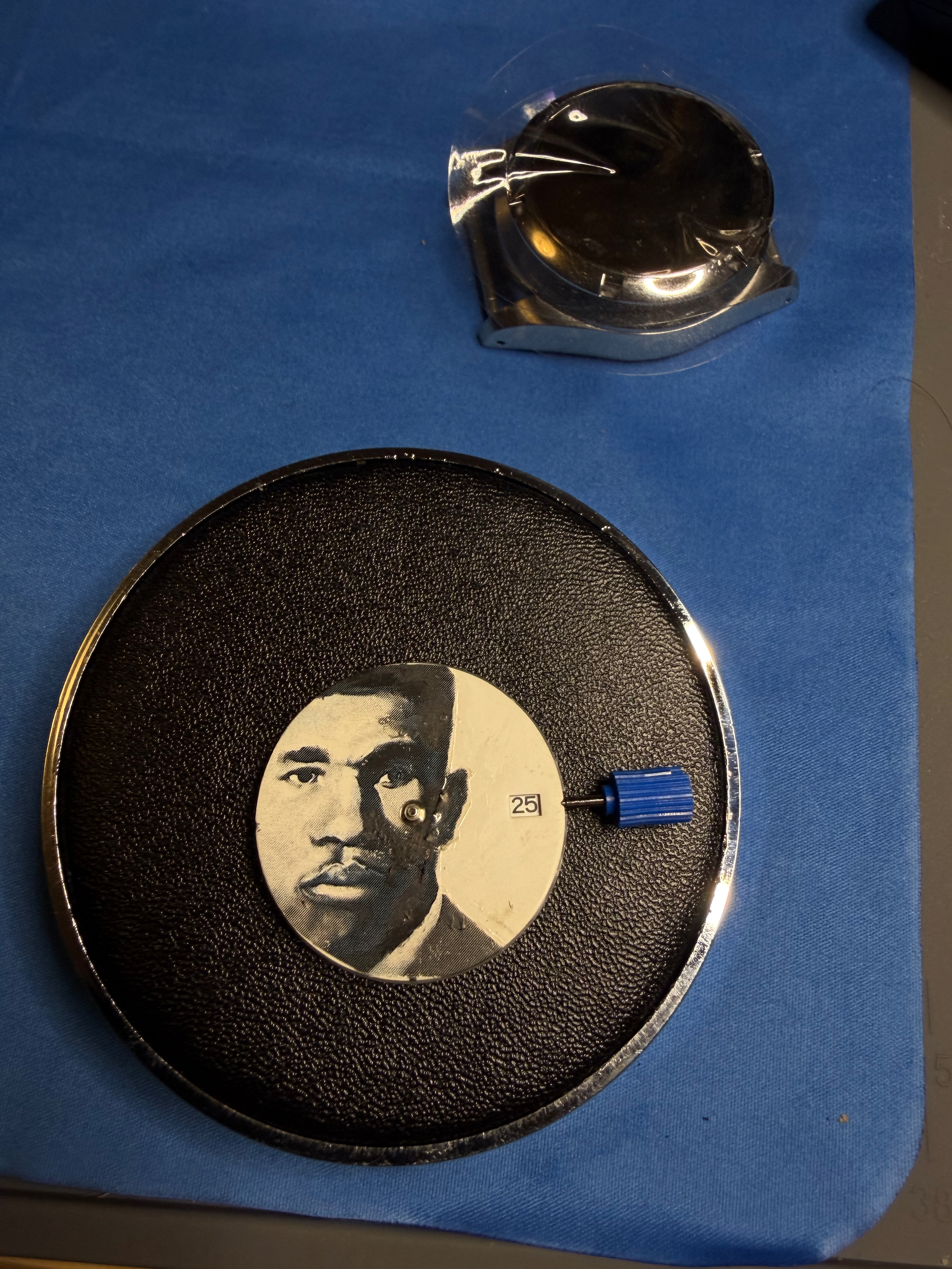 A transferred booking-photograph dial on the movement, indexed 25
